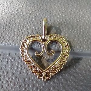 Women's gold tone reversible heart pendant.